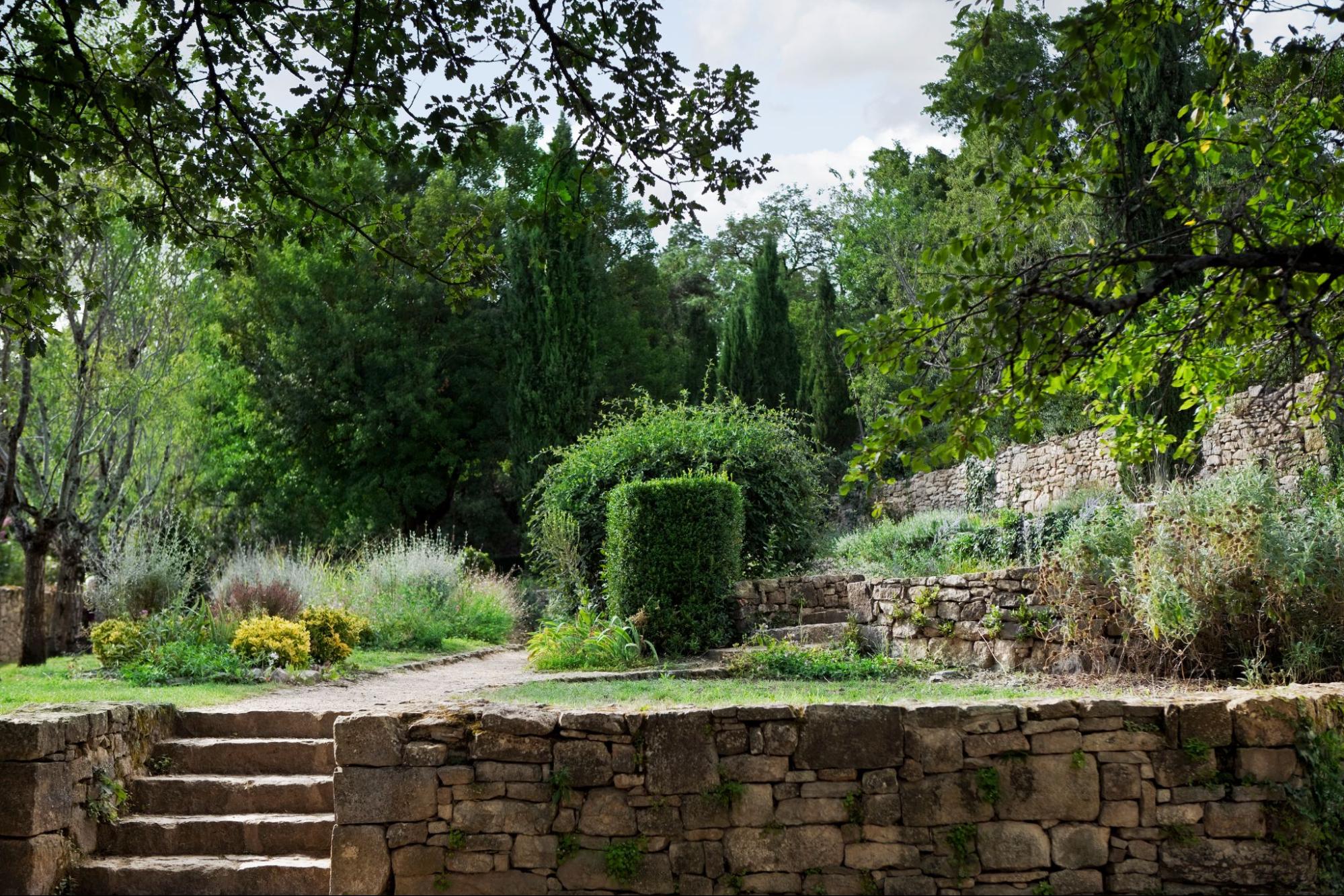 Terraced garden built within retaining walls, showcasing layered landscaping and lush greenery