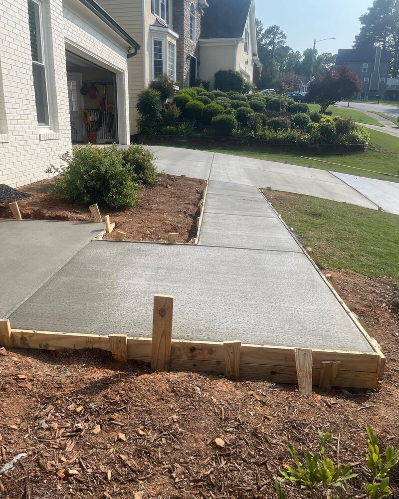 Concrete driveway replacement and new front porch in progress.