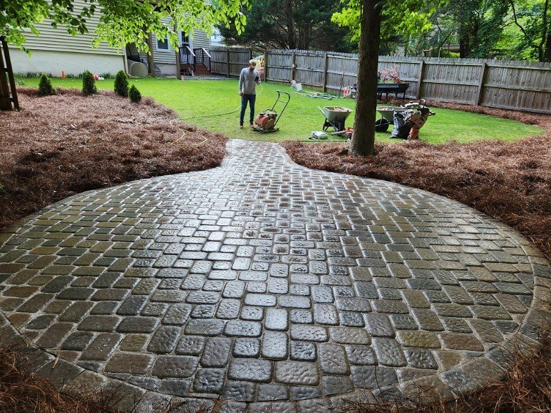 Circular fire pit area with Hessit Dutch cobble driftwood pavers.