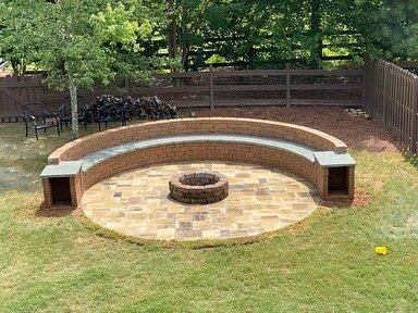 Paver patios, seating wall with wood storages and fire pit. Belgard Origin 12 Avondale.