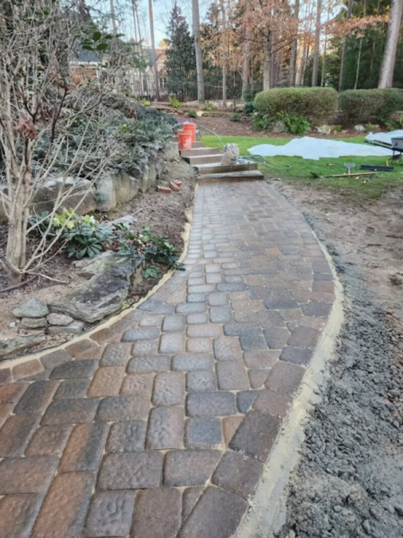 Wide retaining wall with Rockwood Classic grey blocks and caps, tan stepping stones