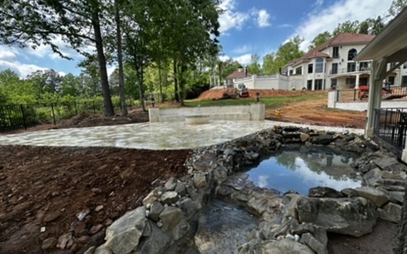 Natural stone water feature with pond and paver patio in Metro Atlanta